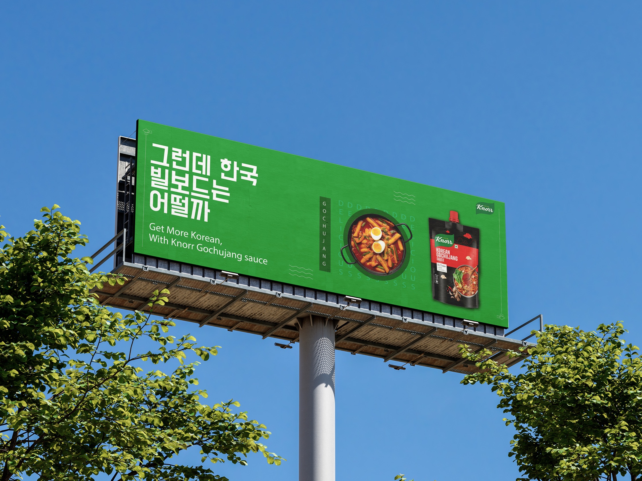 A green Knorr billboard standing above the treetops against a blue sky.